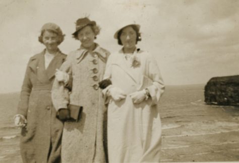 The Scanlon Sisters (left to right), Nora, Eileen, and Johanna dressed in their best take to the coast of County Kerry, Ireland. The photograph was taken after the Easter Rising in Ireland.