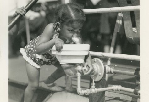 Toddler Girl drinking from water fountain, 1941